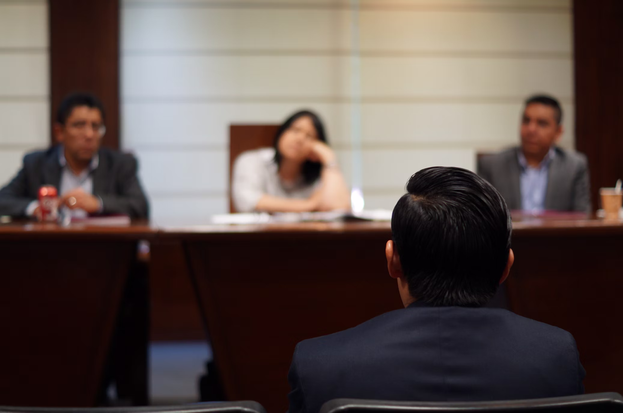 A speaker facing a panel in a hearing room